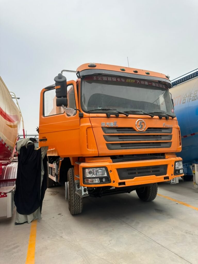 Orange Shacman heavy truck available through Hind Procurement