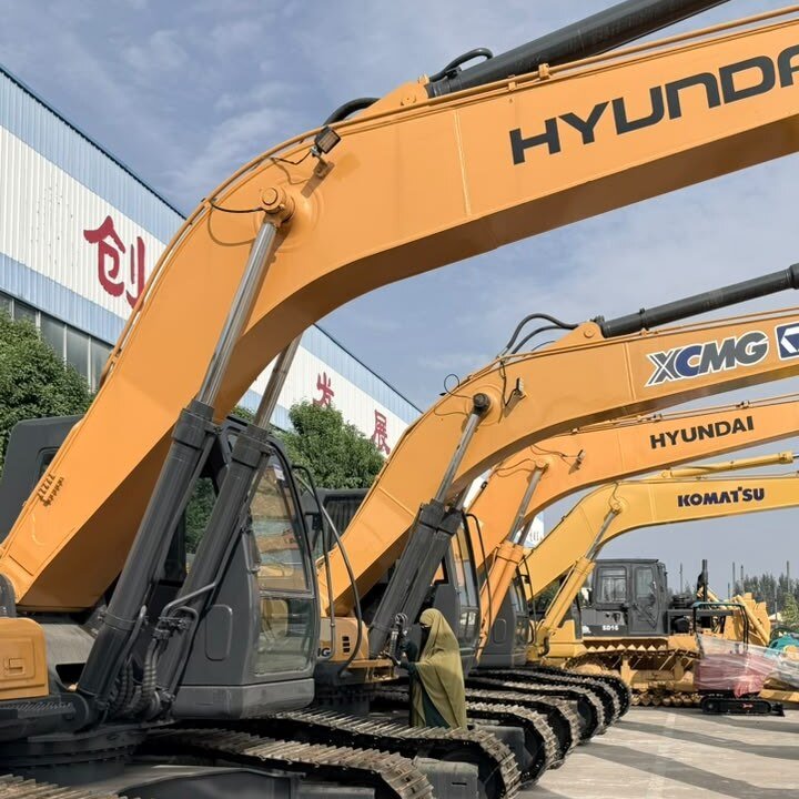 Close-up of an excavator boom, hydraulic cylinders and steel tracks in a China equipment yard