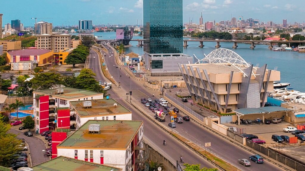 How to Find a Reliable China Agent in Nigeria (and What to Ask Before You Pay) Lagos skyline with the Civic Centre Towers beside the lagoon on a bright day